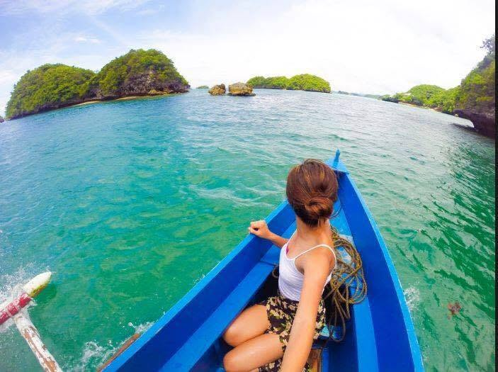 Traveler exploring tropical islands by boat